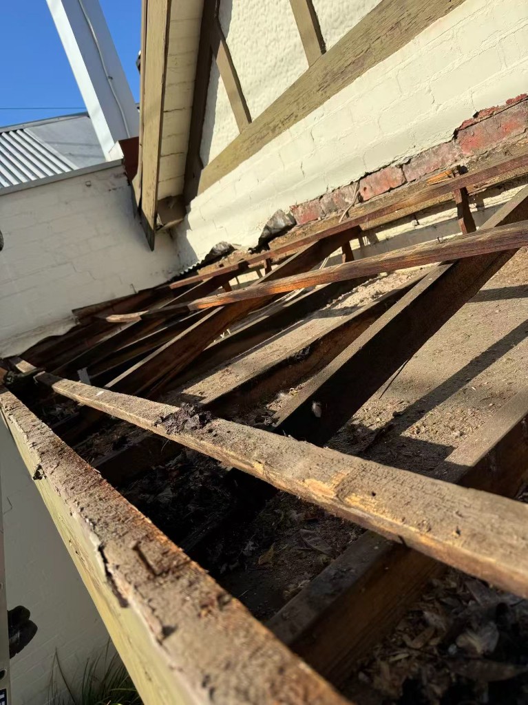 Pre-finish stage exposing old front structure before final facade works