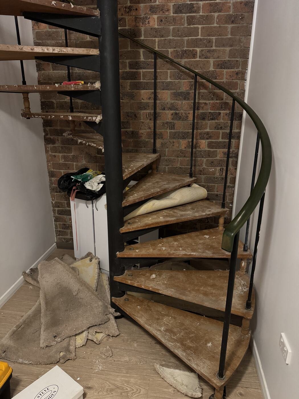 Old carpet stripped off the spiral staircase treads, exposing the timber beneath