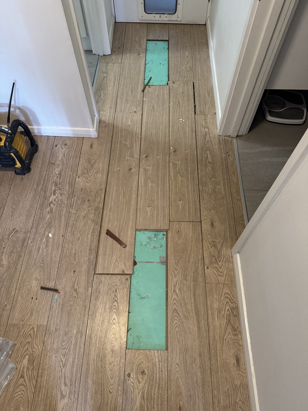 New floating timber floorboards going down, with sections of underlay still exposed