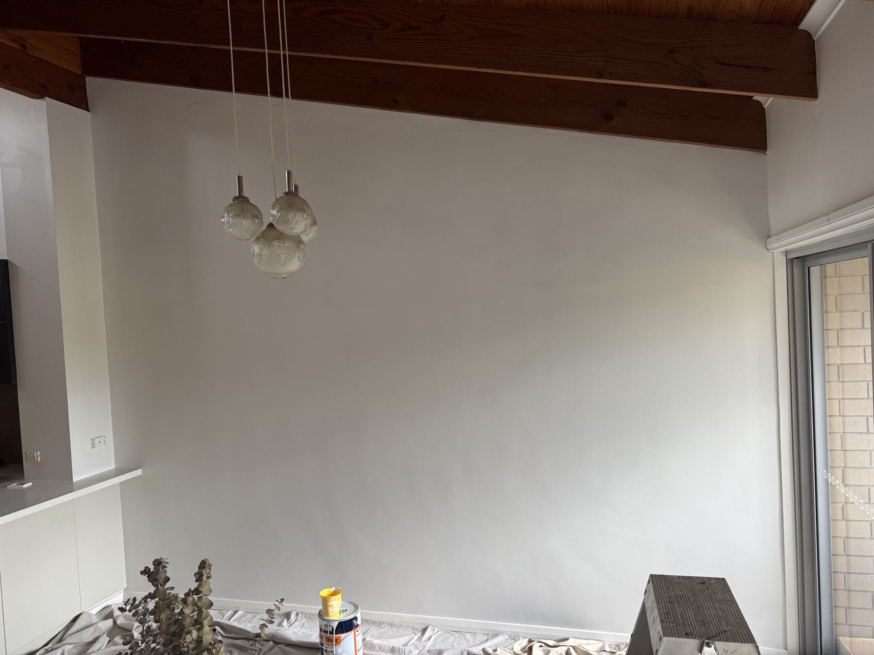 Interior wall freshly repainted with drop sheets down during the repaint