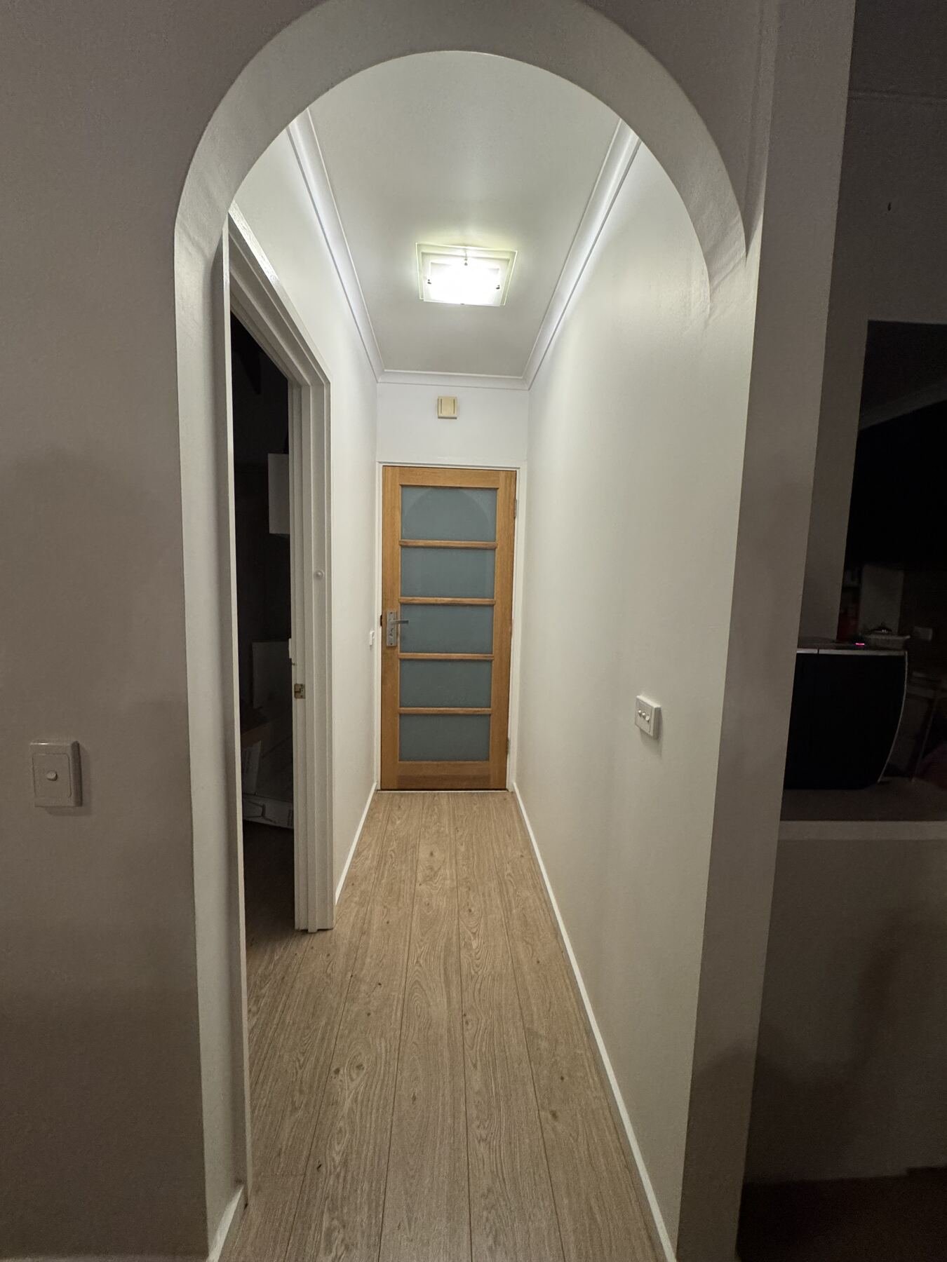 Finished arched hallway with new timber floors and fresh paint