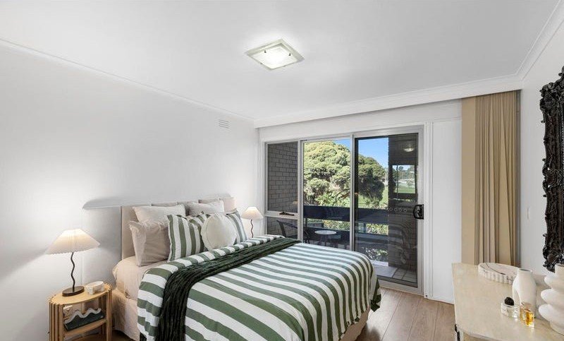 Bedroom with balcony access, styled for inspection