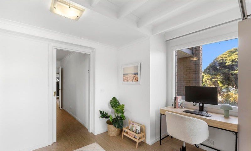 Home office nook with a desk beneath the window