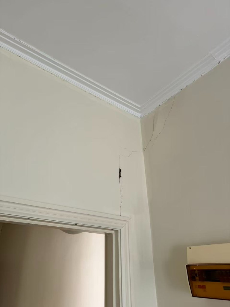 Room with wall cracks requiring preparation before painting
