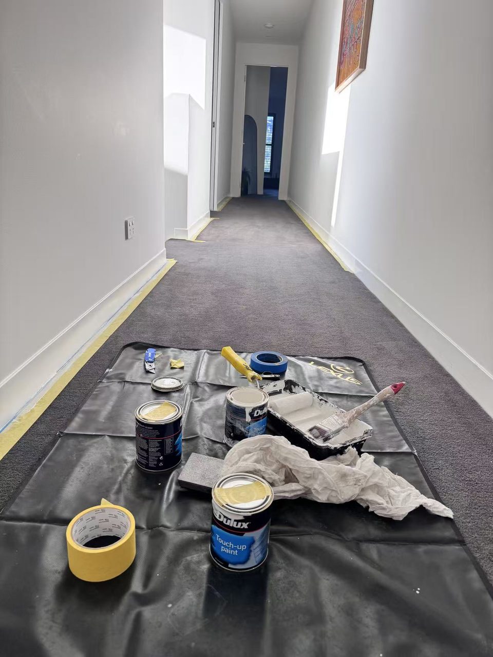 Caulfield pre-auction paint touch-ups — hallway walls touched up with artwork rehung in natural light