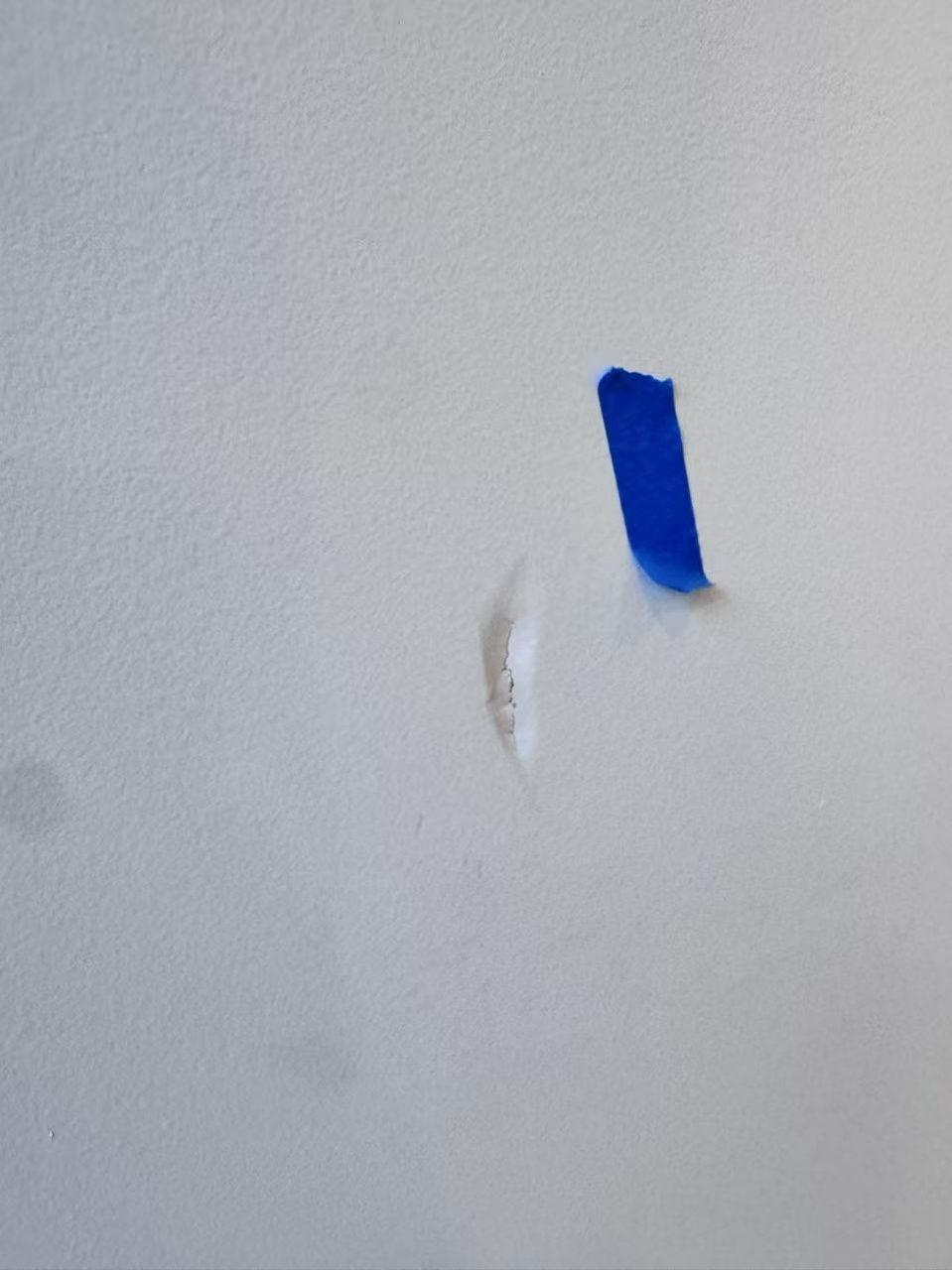 Caulfield pre-auction paint touch-ups — minor wall dent marked with tape, ready for filling and touch-up