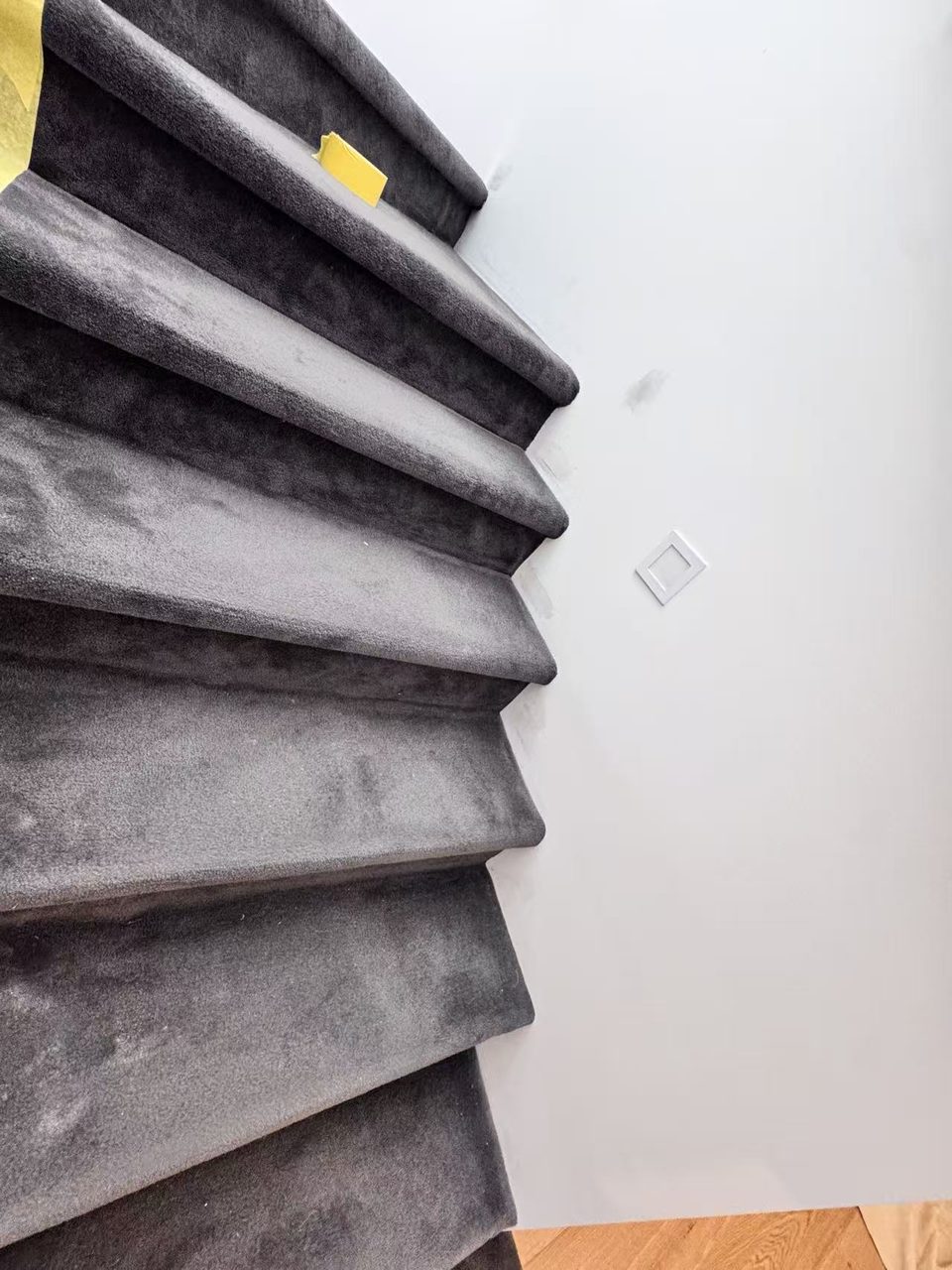 Caulfield pre-auction paint touch-ups — stairwell wall patched and sanded beside the light switch