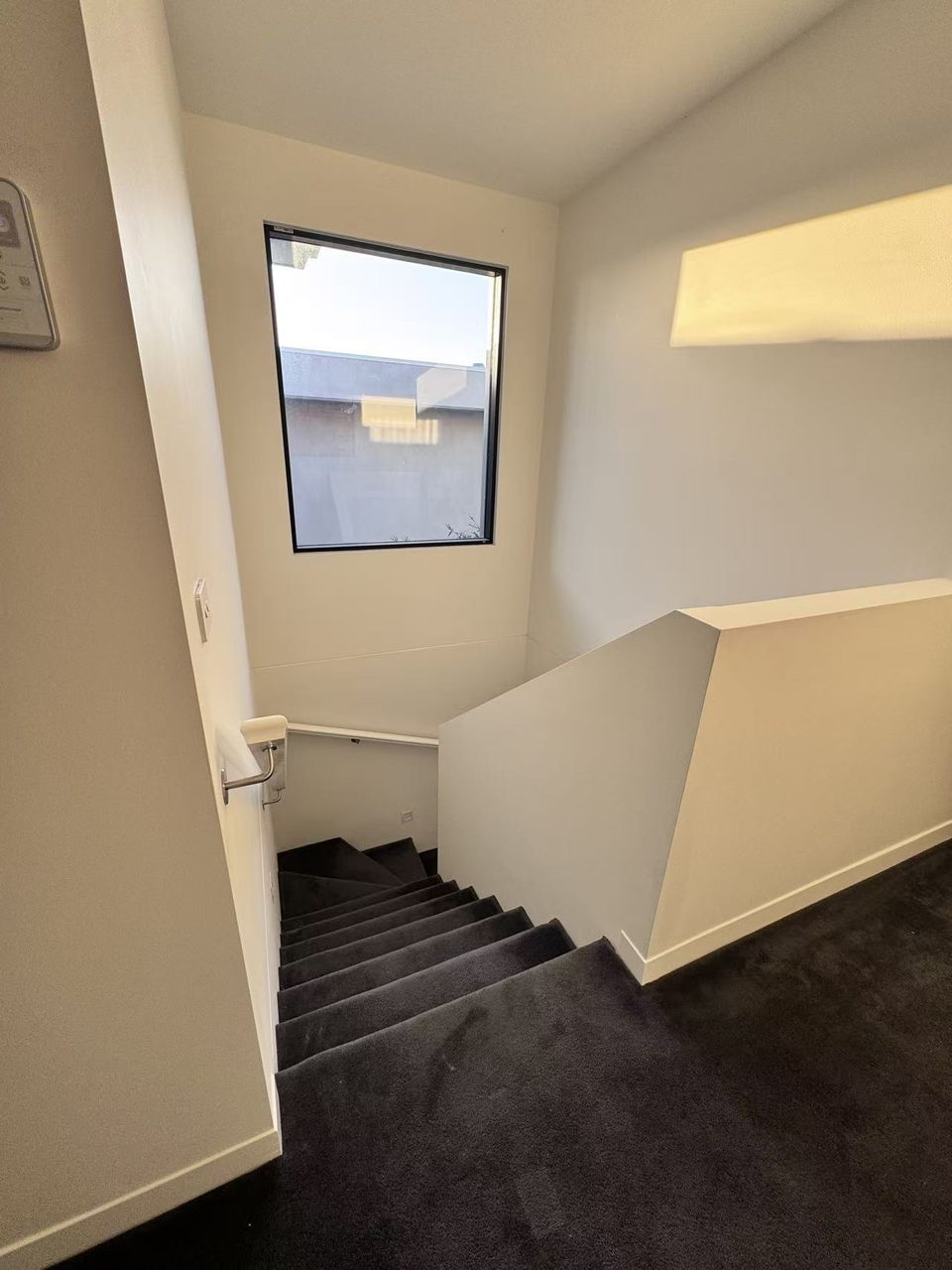 Caulfield pre-auction paint touch-ups — stairwell landing and window with fresh, clean walls
