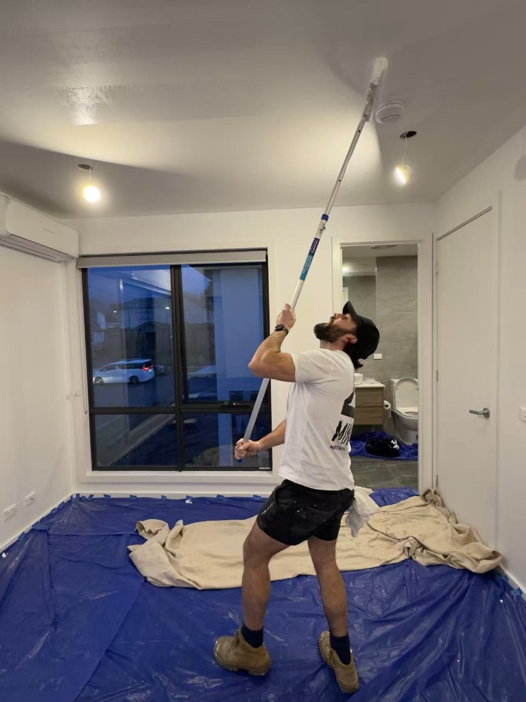Chadstone full internal repaint — ceiling in progress, roller on extension pole and floor protection