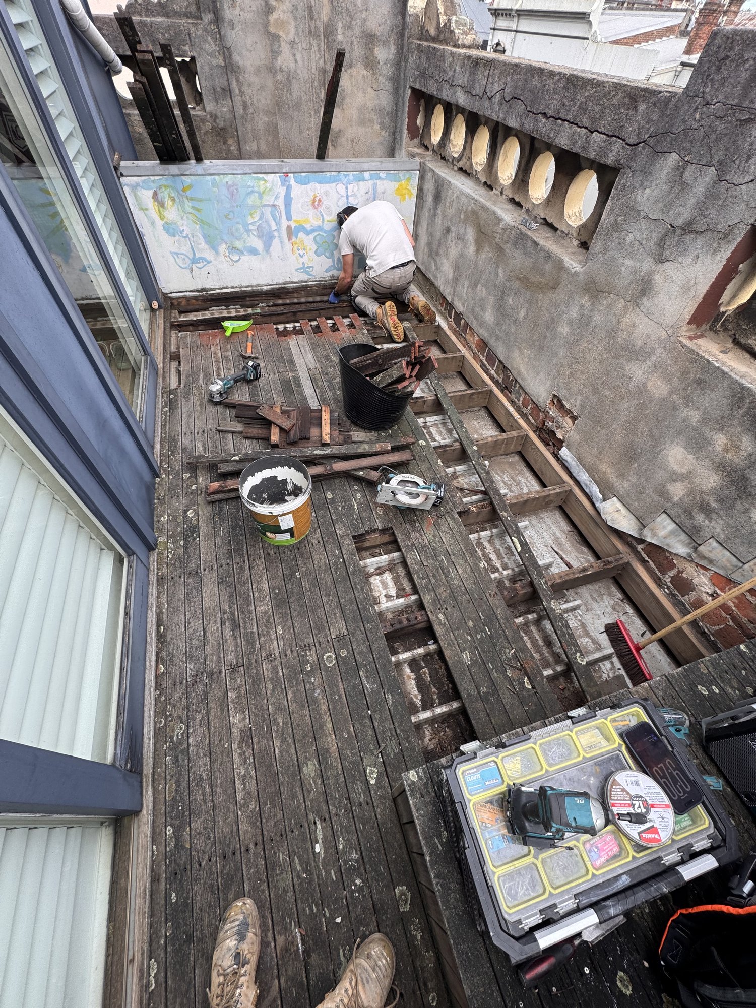 Stripping out the last of the old merbau decking back to the structure