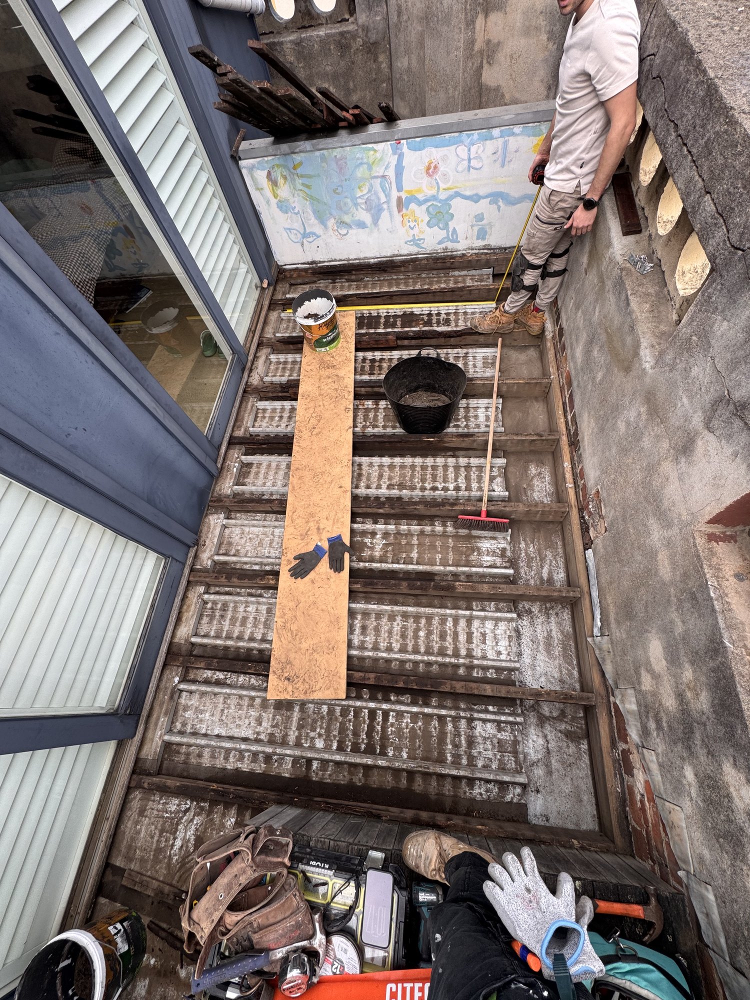 Deck stripped back to bare joists over the roof, ready for the new subframe