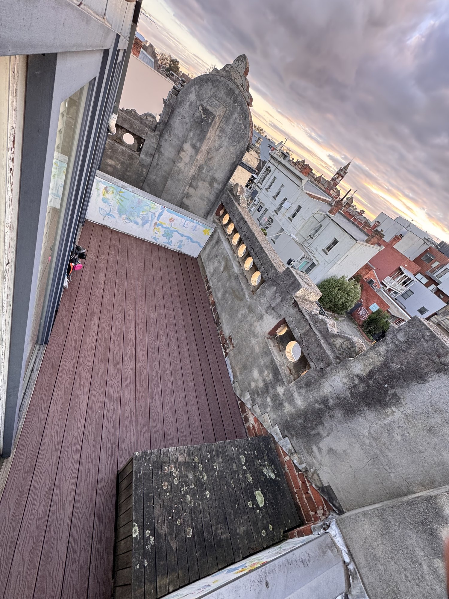 Finished low-maintenance composite rooftop deck at sunset