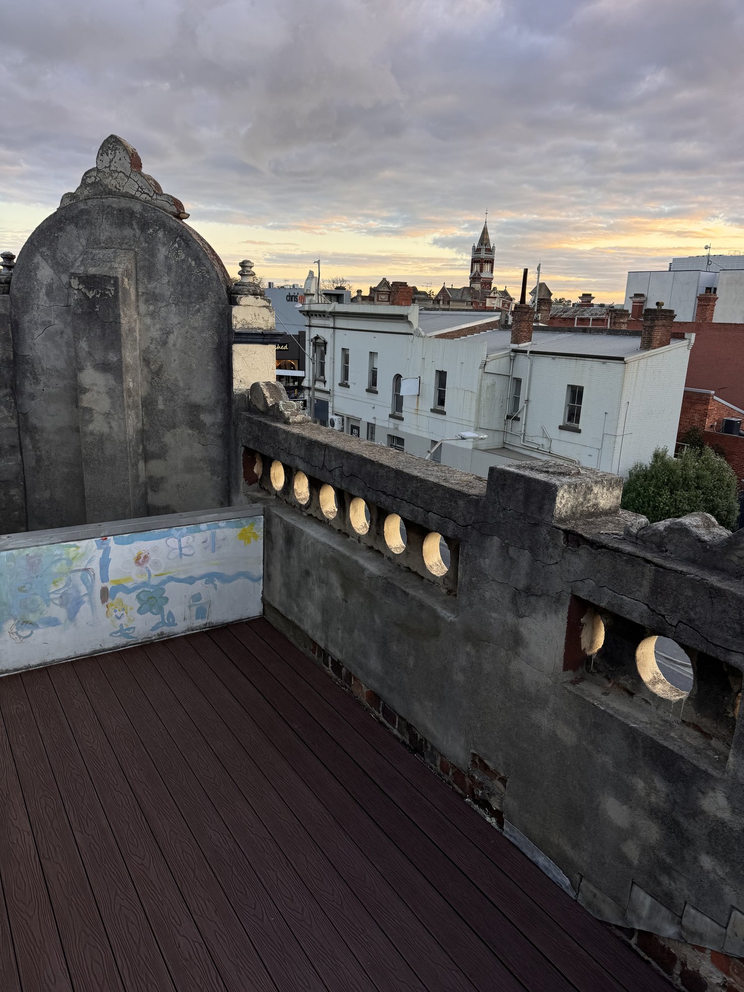Completed Hawthorn rooftop deck rebuild with sunset views over the rooftops