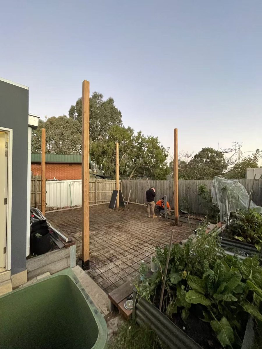 Steel reinforcement mesh laid over the prepared base with timber posts set in position