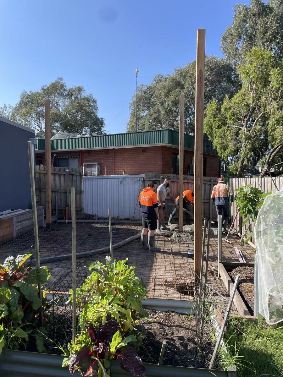 Concrete being pumped and placed across the reinforced slab