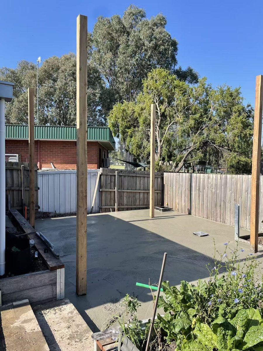 The cured concrete slab with timber posts standing, ready for framing